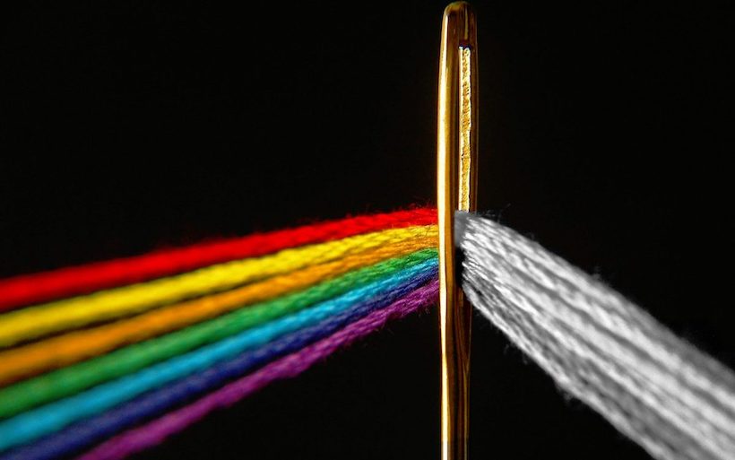 Close up of a needle with a number of grey threads which turn multicoloured as they pass through its eye. This represents the different types who people who are starting online businesses