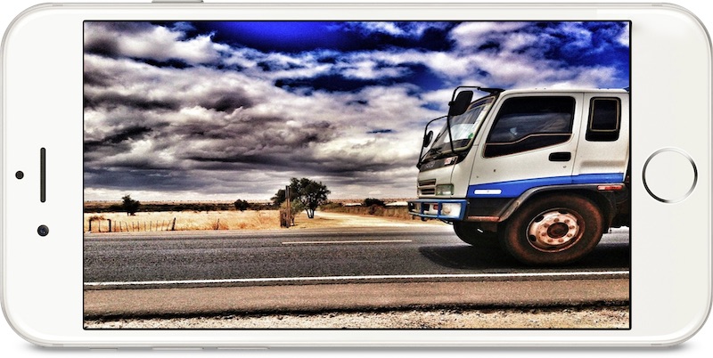 affiliate marketing or e-commerce - image of an iphone screen showing a truck on a desert highway. This represents the idea of e-commerce