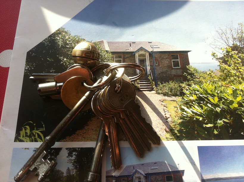 The brochure of the house I live in with the keys to it on top. A good metaphor to finding the key to getting started with a home business.