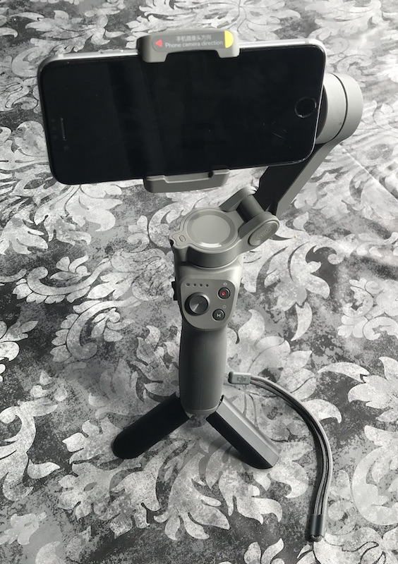 DJI Osmo 3 smartphone gimbal pictured on its mini tripod